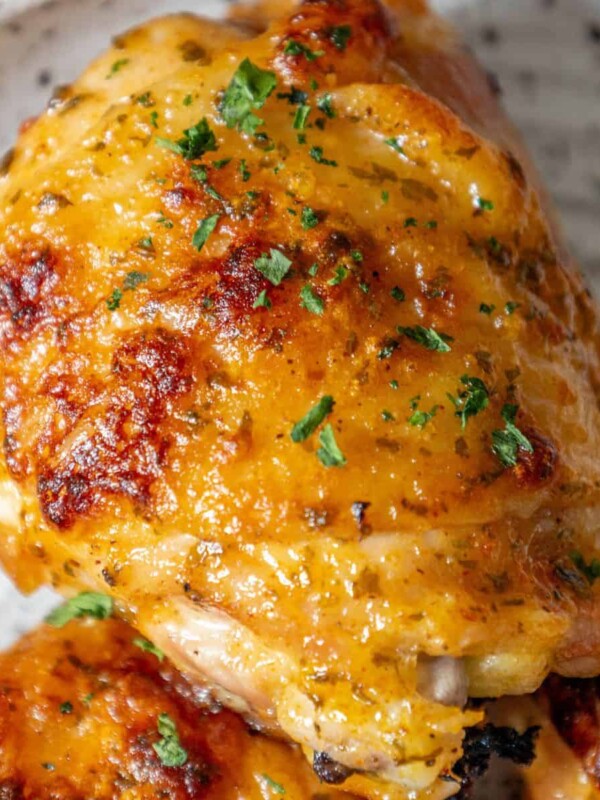 A plate of baked ranch chicken with parsley on it.