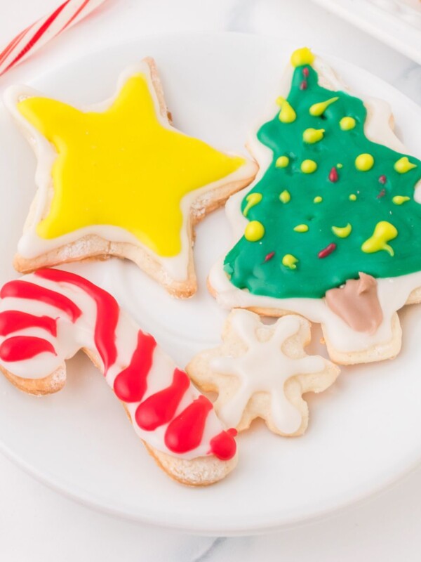 picture of iced christmas cookies on a white plate on a table