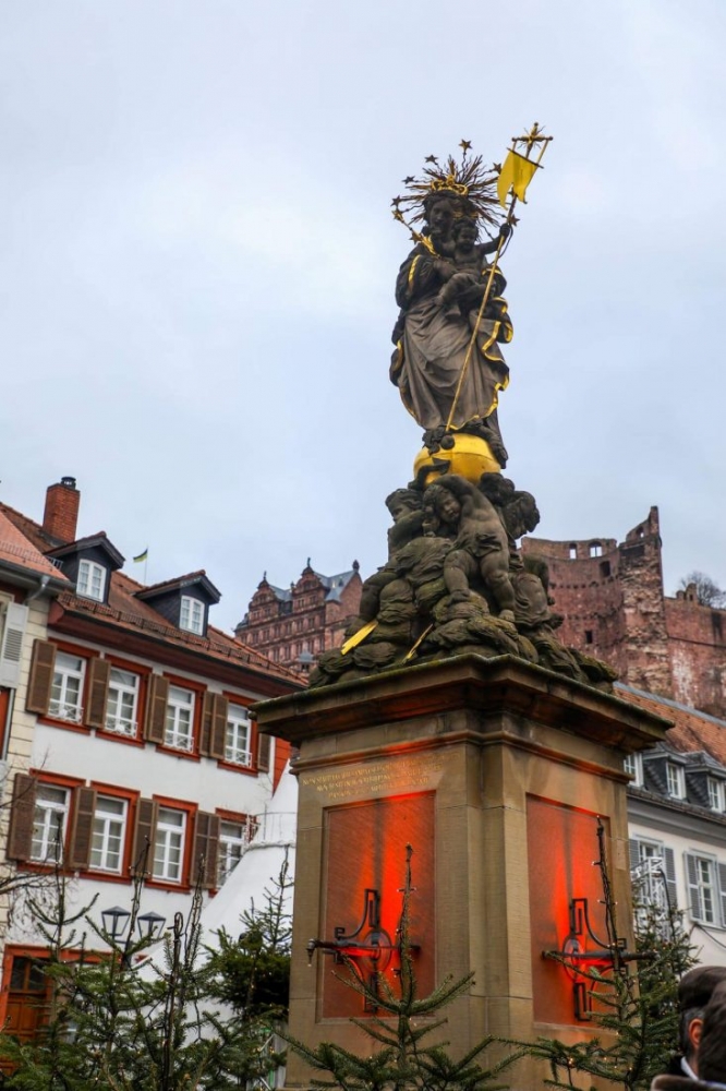 A Christmas-themed statue in Heidelberg of a man holding a torch.