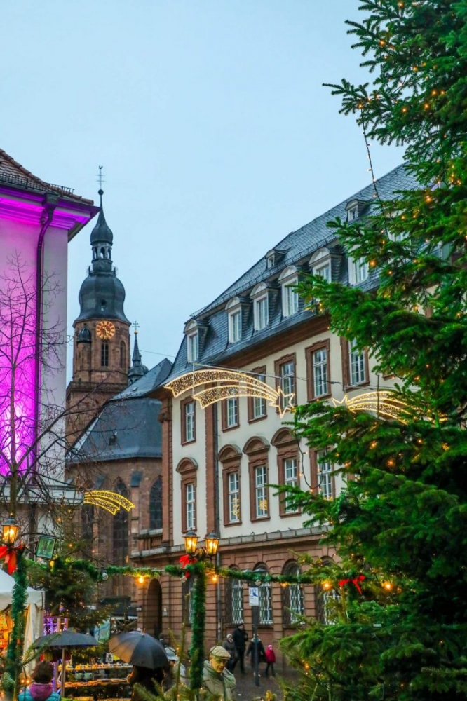 Christmas market in Heidelberg with clock tower.