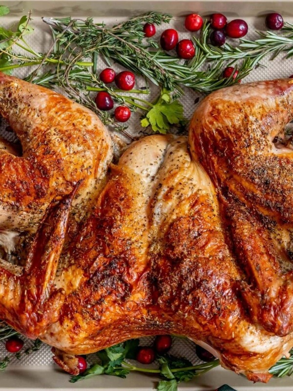 picture of a spatchcocked baked turkey on a baking sheet