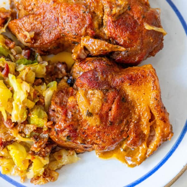 A plate with Polish country style ribs, chicken, and cabbage on it.
