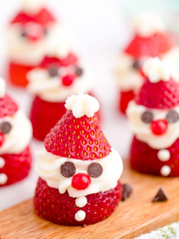 strawberry sliced and topped with whipped cream and chocolate chips to look like santa