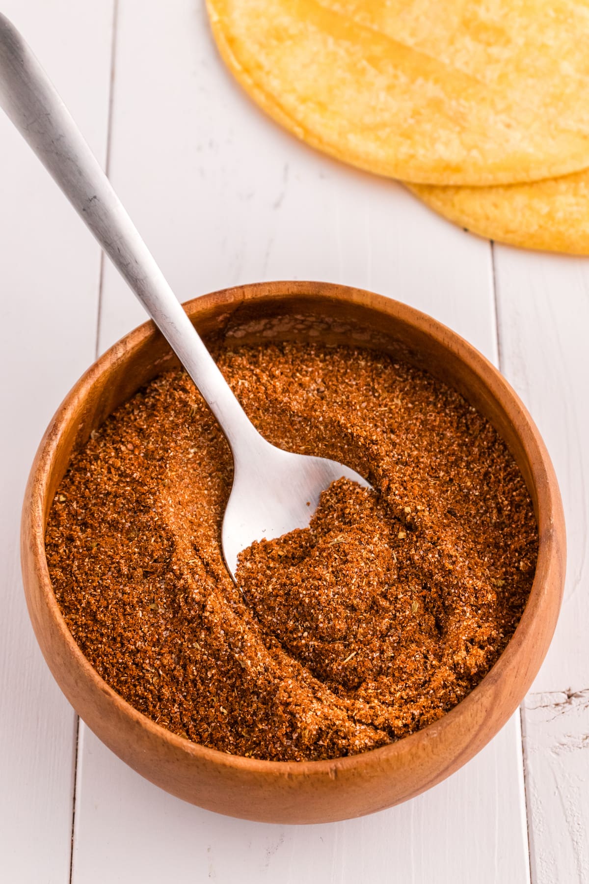 taco seasoning on a spoon in a bowl of taco seasoning