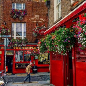 A man is walking down a street in Dublin, Ireland.