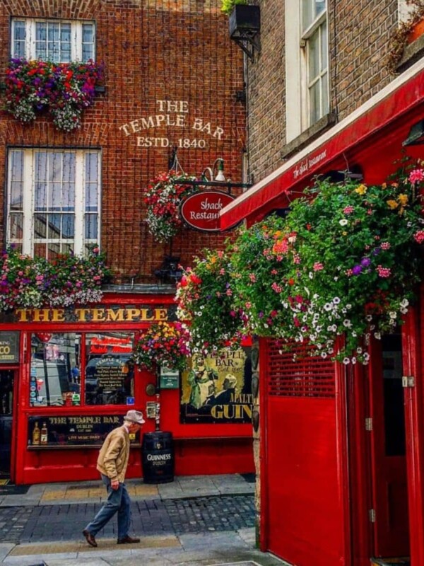 A man is walking down a street in Dublin, Ireland.