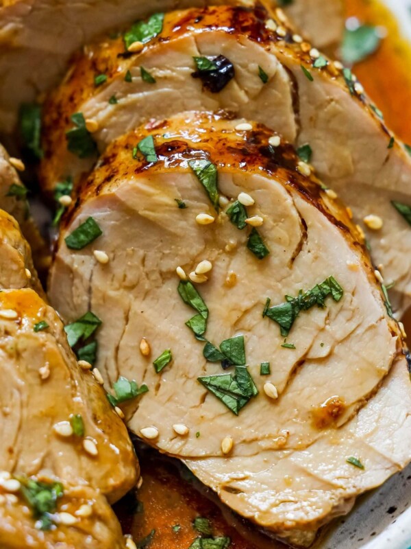 picture of sliced pork tenderloin in teriyaki sauce with sesame seeds on top