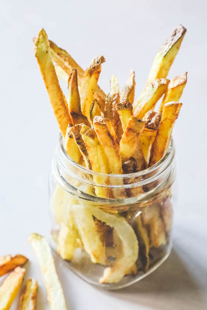 Glass jar filled with crispy air fried french fries.