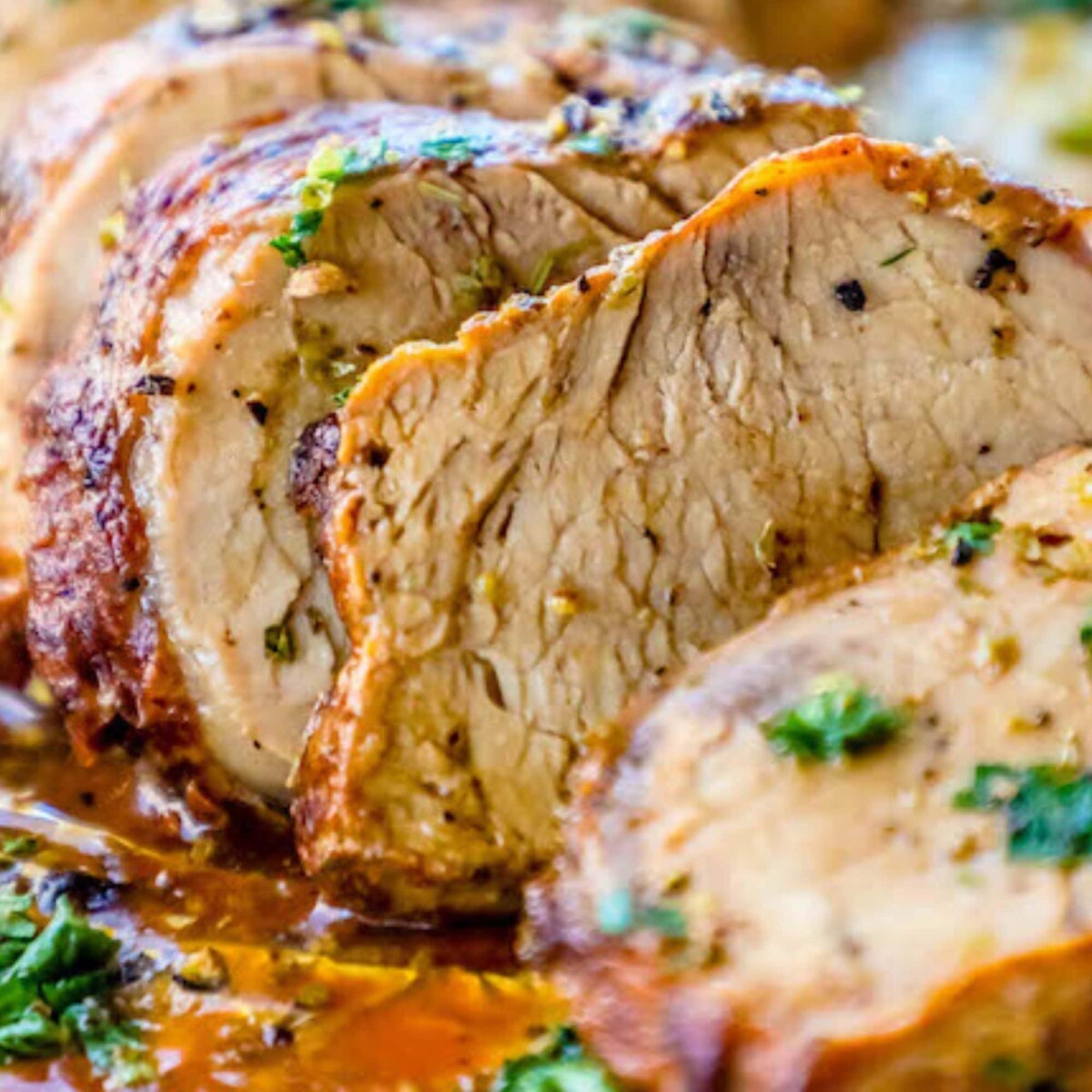 picture of pork tenderloin in garlic butter on aluminum foil
