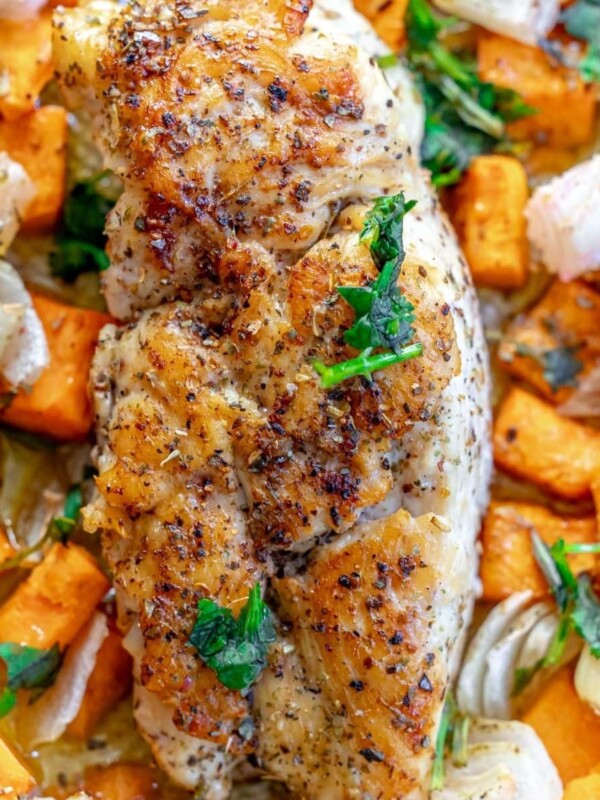 picture of turkey tenderloin on a sheet pan with sweet potatoes and onions